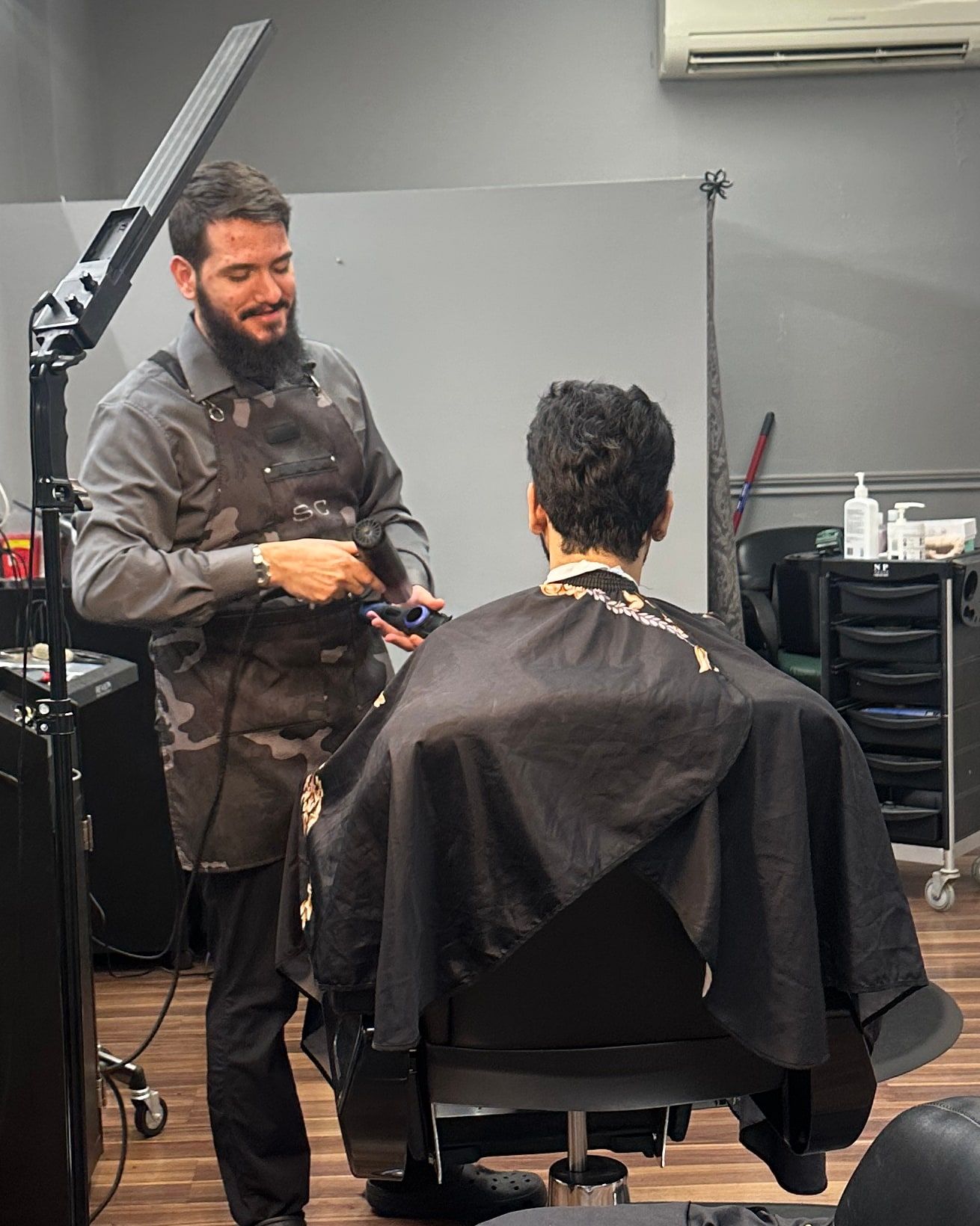Barber working on a client at the chair