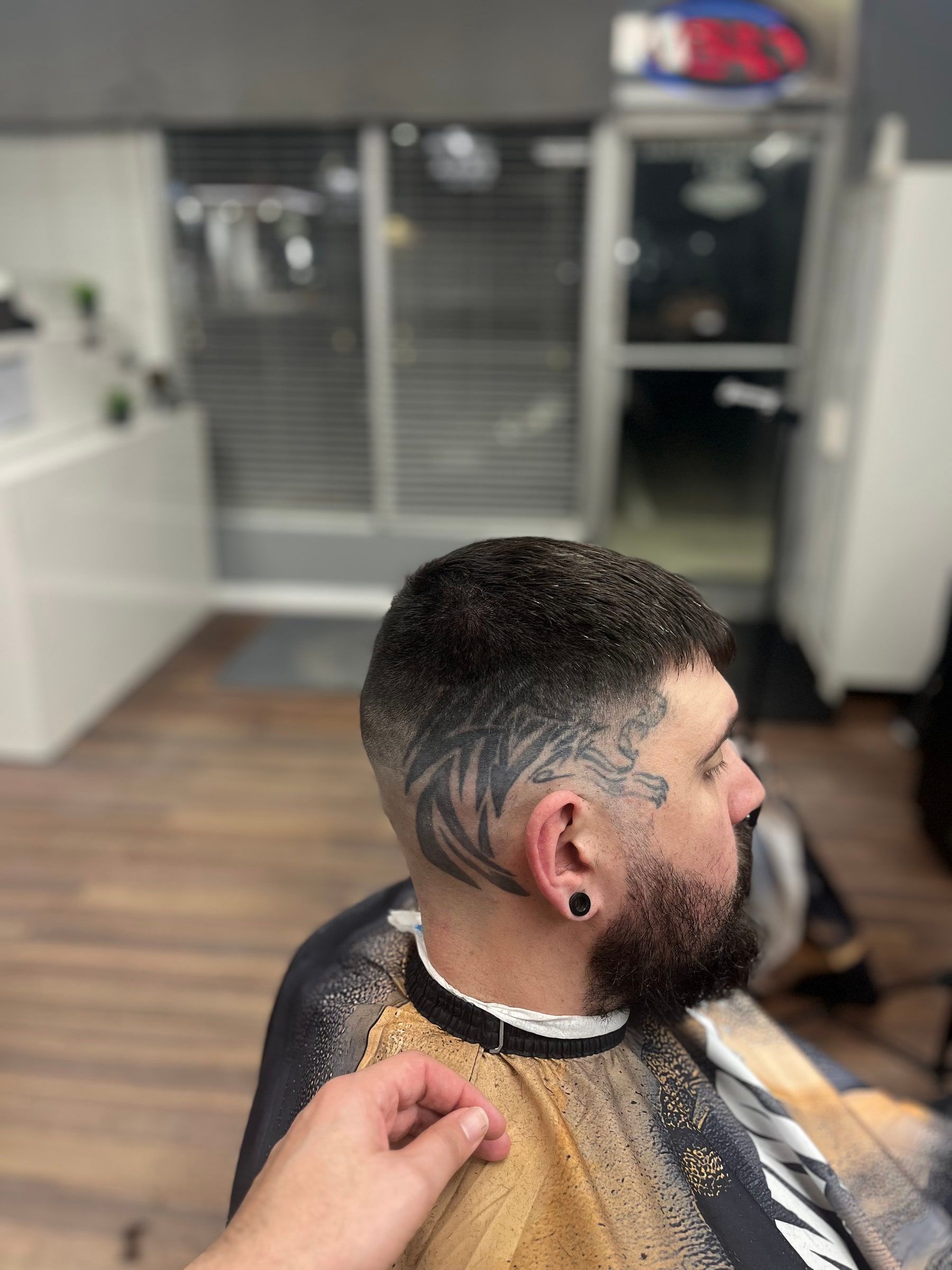 Skin fade with a textured fringe and a freehand hair design